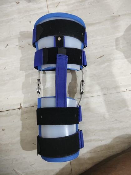 Hinged knee orthosis in thermoplastic with padded strapping