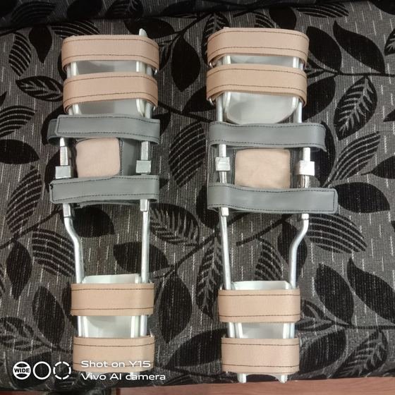 Traditional metal upright KAFO pair with padded cuffs, made at Limbgenixx