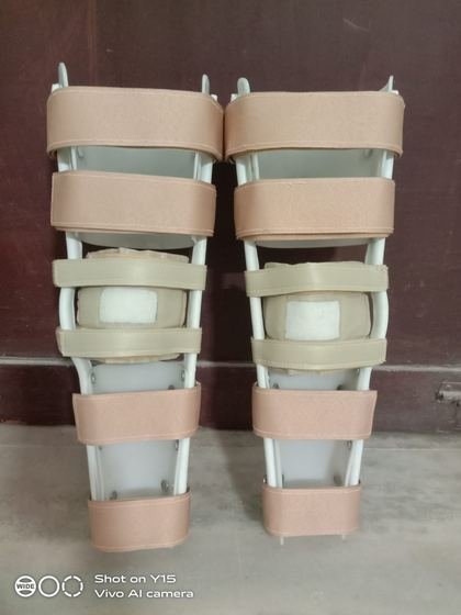 Pair of KAFOs with thigh and calf cuffs and elastic strapping