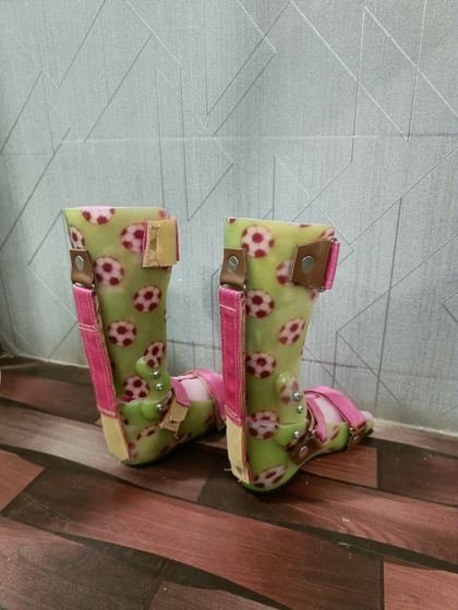 Rear view of a custom paediatric AFO pair showing strap and trimline detail