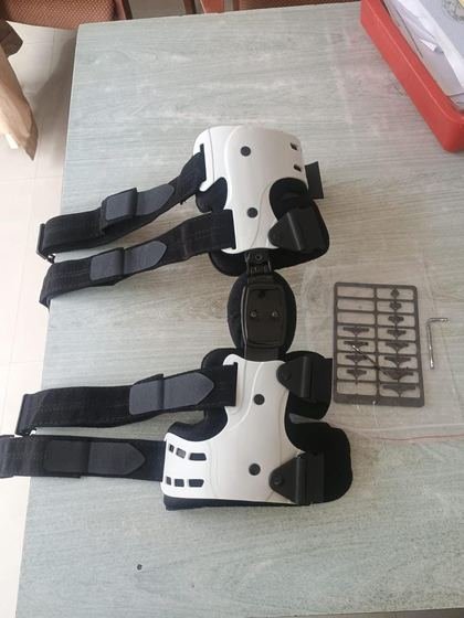 Pair of hinged post-operative knee braces with adjustable stops