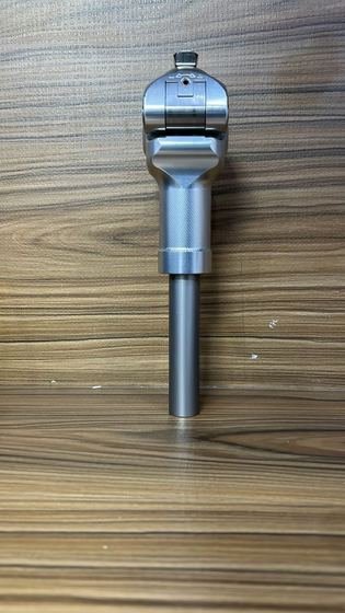 Prosthetic knee joint showing friction and extension control adjusters